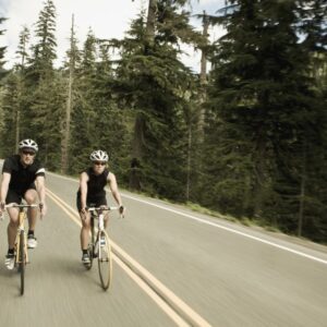 man and woman bicycling though the forest royalty free image 1675712148
