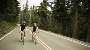 man and woman bicycling though the forest royalty free image 1675712148